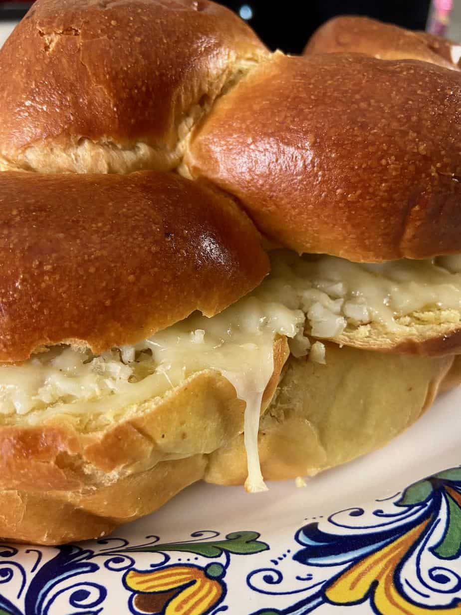 Challah loaf oozing with roasted cauliflower and cheese spread.