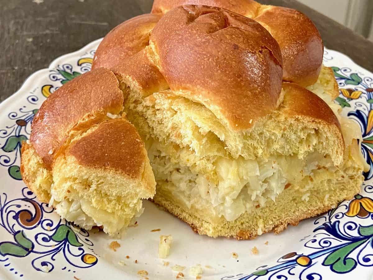 Challah bread loaf stuffed with roasted cauliflower spread and sliced.