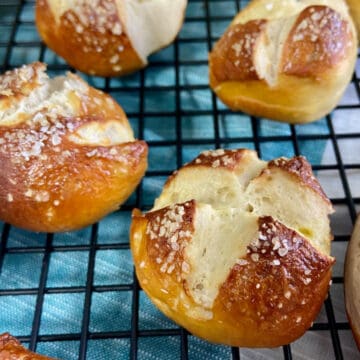 Pretzel balls on black wire rack.