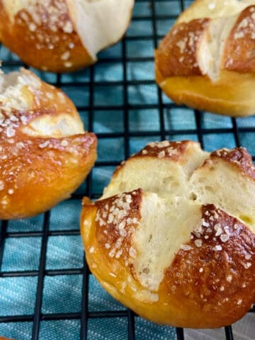 Pretzel balls on black wire rack.