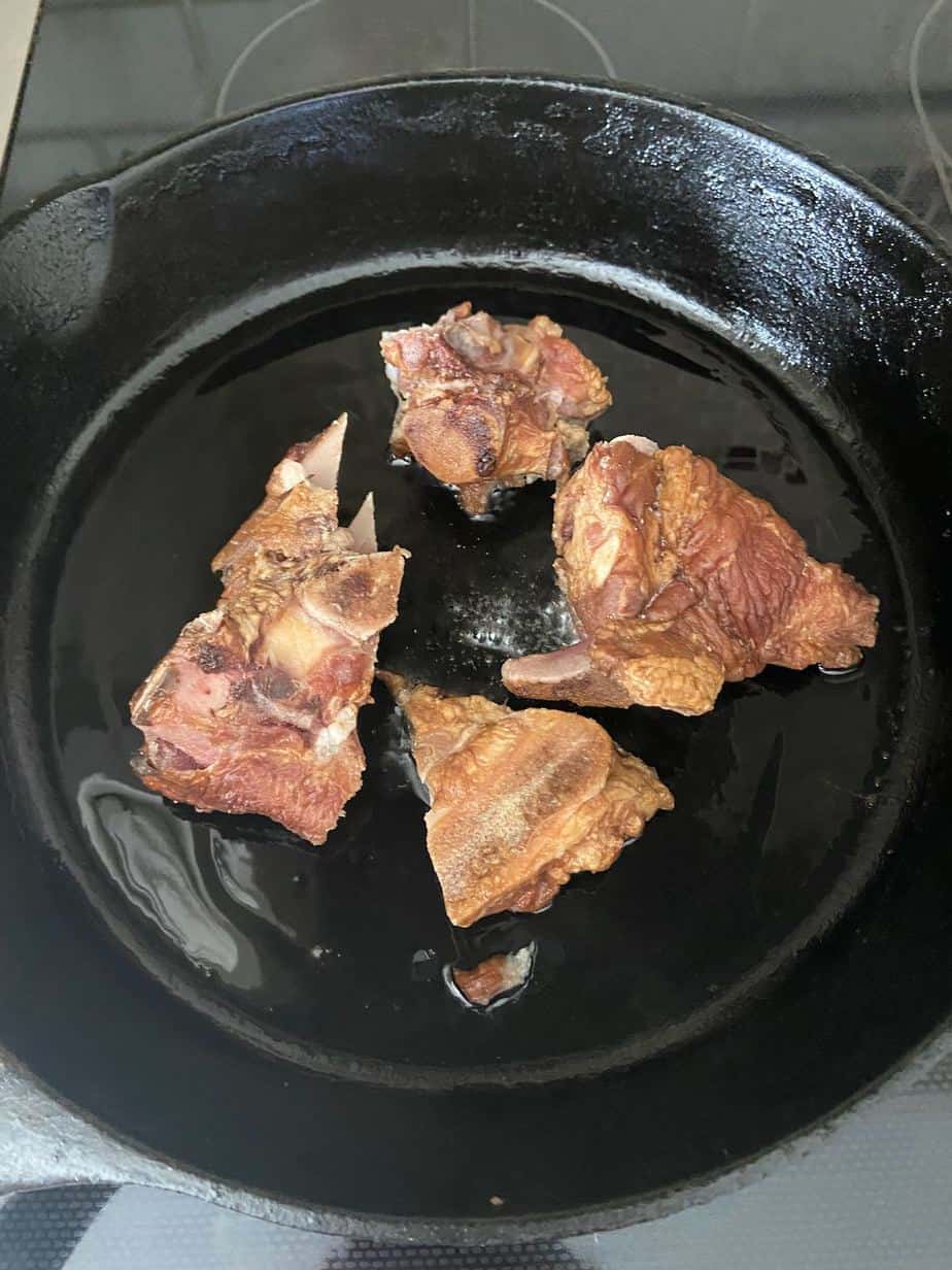 Smoked ham hocks in cast iron skillet.