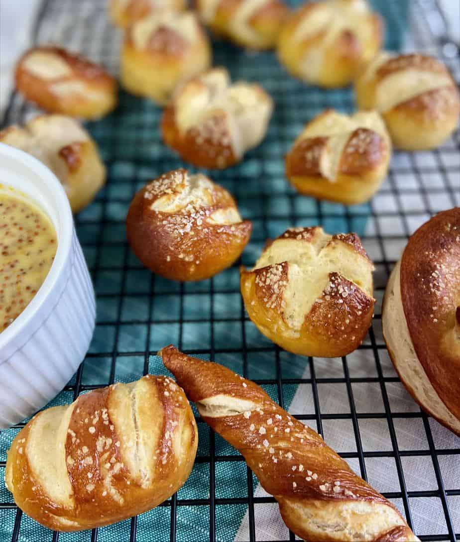 Pretzel balls on black wire rack.