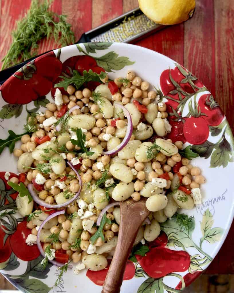 Gnocchi and chickpeas in decorative bowl.