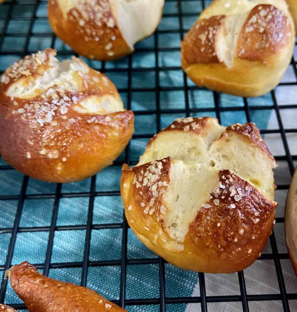 Pretzel balls on black wire rack.