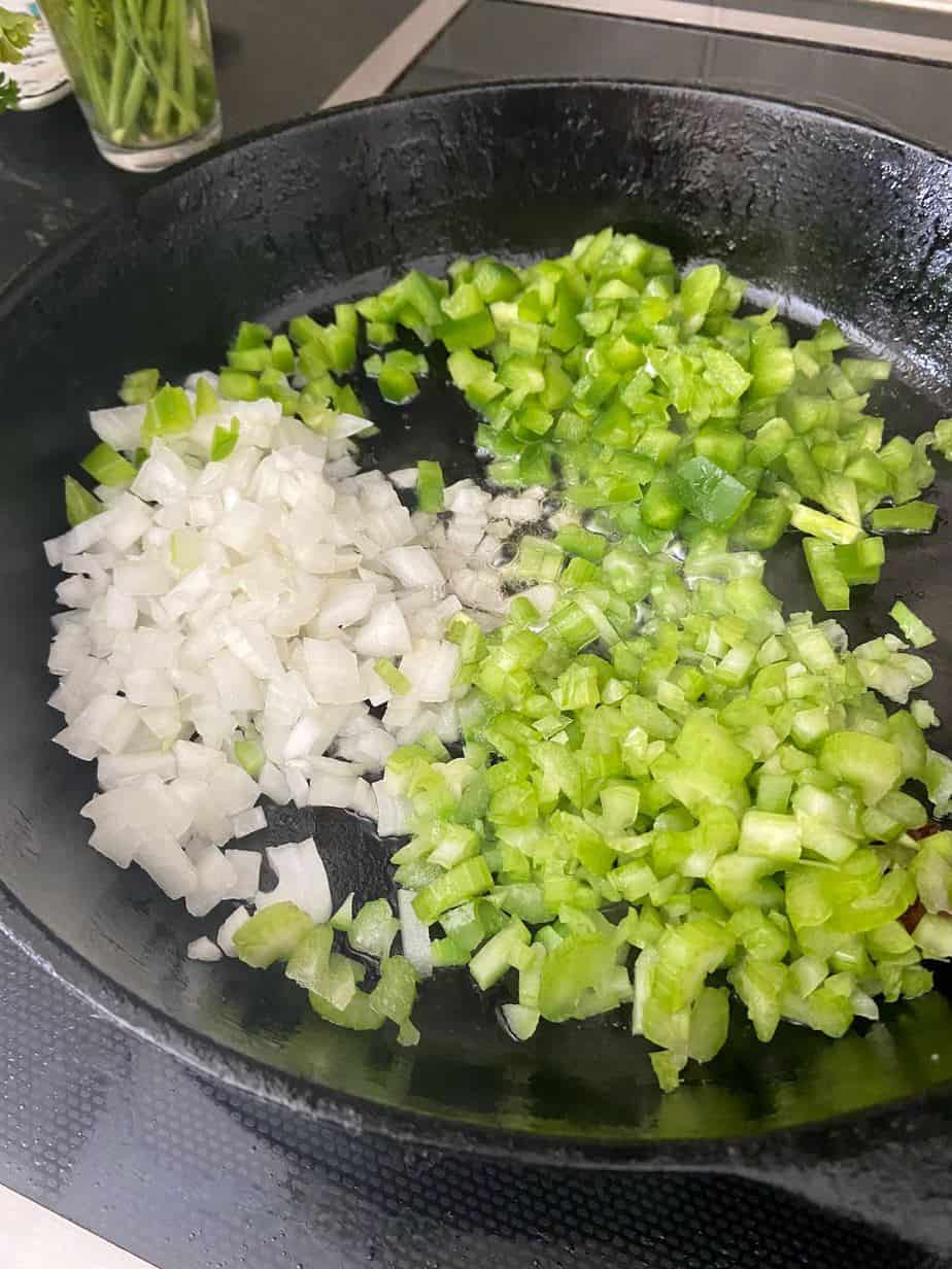 Chopped onion, celery and bell. pepper in cast iron skillet.