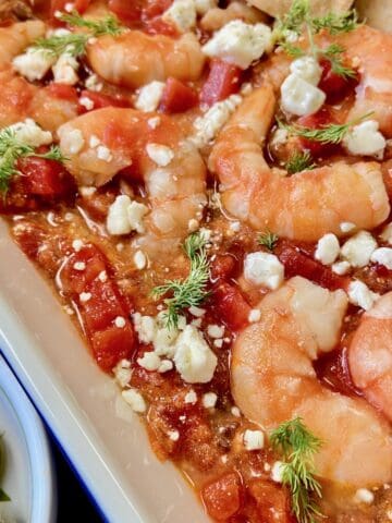 Shrimp Saganaki in white baking dish.