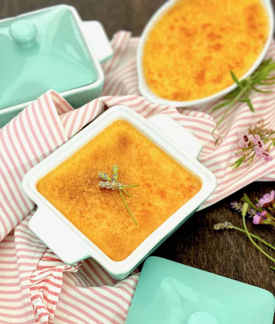 Lavender creme brulee in square ramekin garnished with fresh lavender.