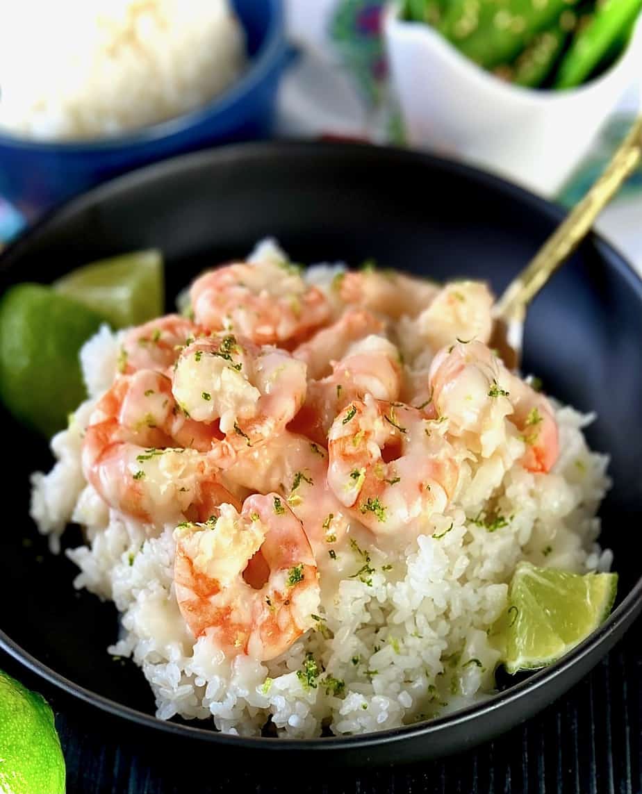 Coconut shrimp in black bowl.