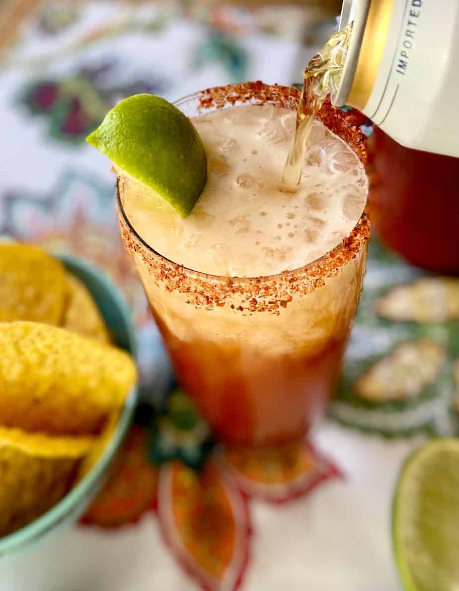 Beer being poured into glass for Mexican Michelada Cocktail.