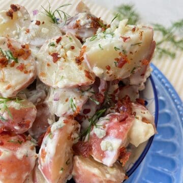 Blue cheese potato salad in blue bowl.