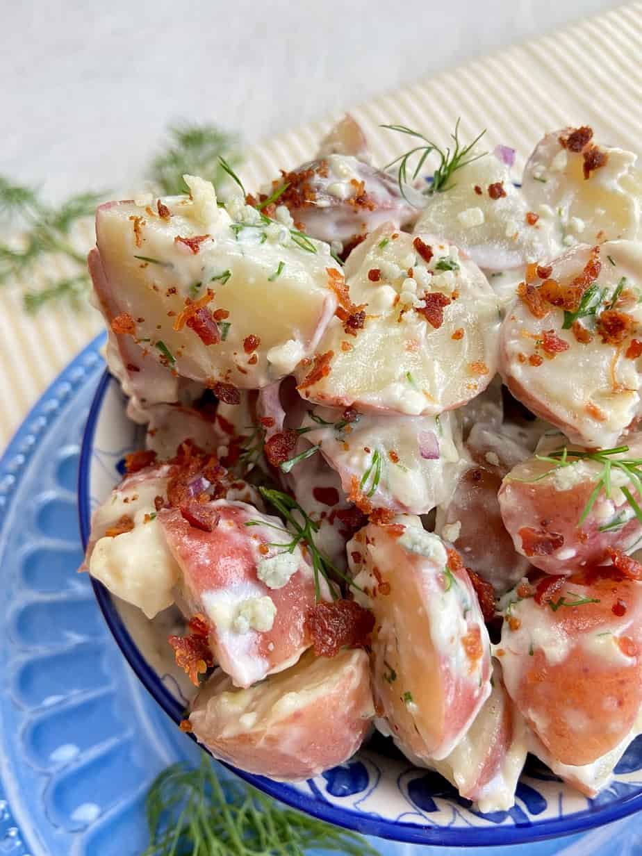 Blue cheese potato salad in blue serving bowl.