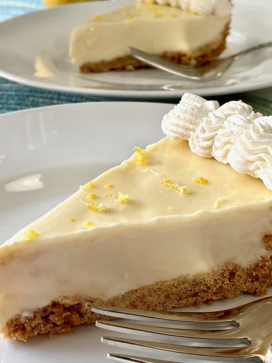 Slice of lemon icebox pie on white plate.