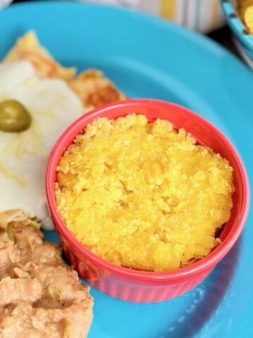 Sweet Corn Tomatilo in red ramekin on blue plate.