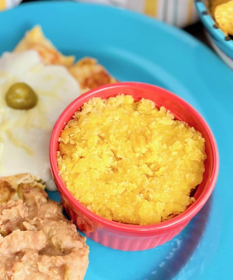 Sweet Corn Tomatilo in red ramekin on blue plate.