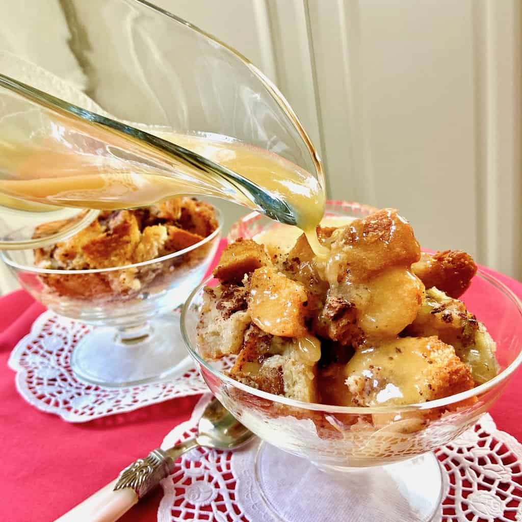 Rum glaze being poured over bread pudding.