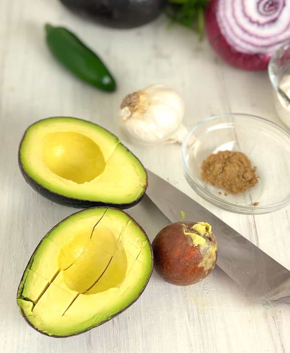 Avocado sliced in half an scored.