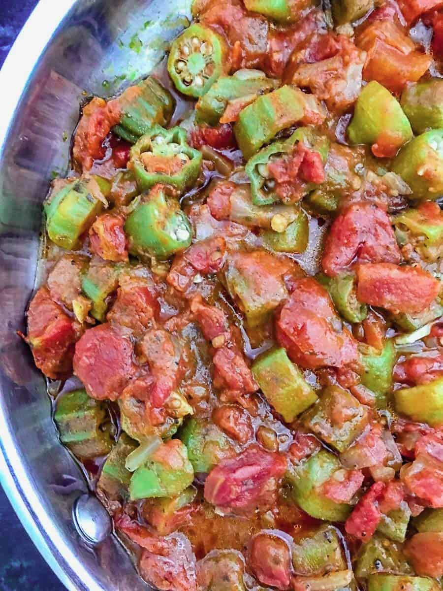 Smothered okra and tomatoes in aluminum skillet.