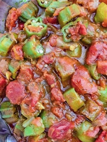 Smothered okra and tomatoes in aluminum skillet.