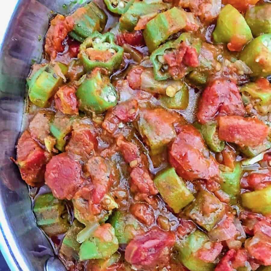 Smothered okra and tomatoes in aluminum skillet.