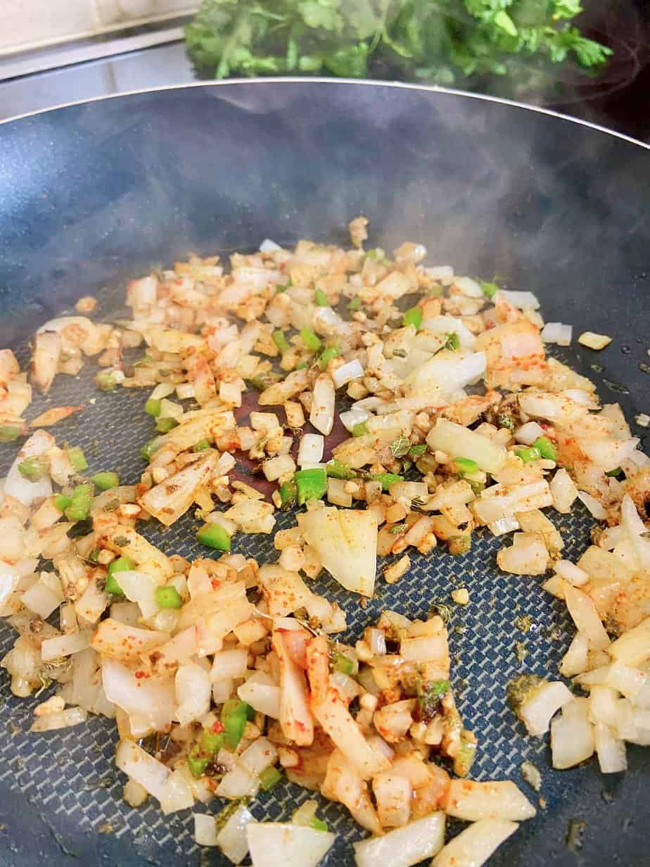 Sauteed onions, garlic and jalapenos in skillet.