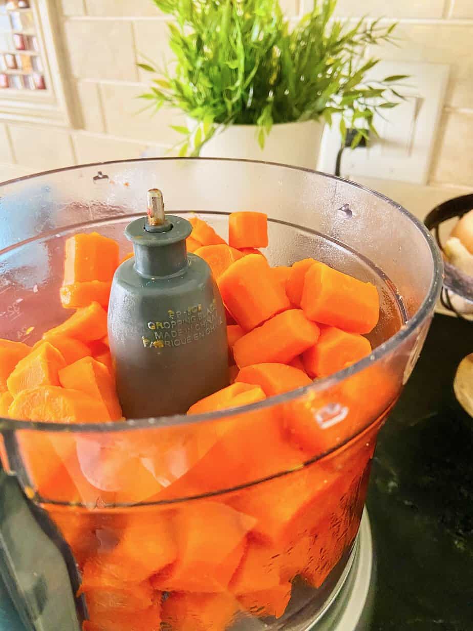 Boiled sliced carrots in food processor.