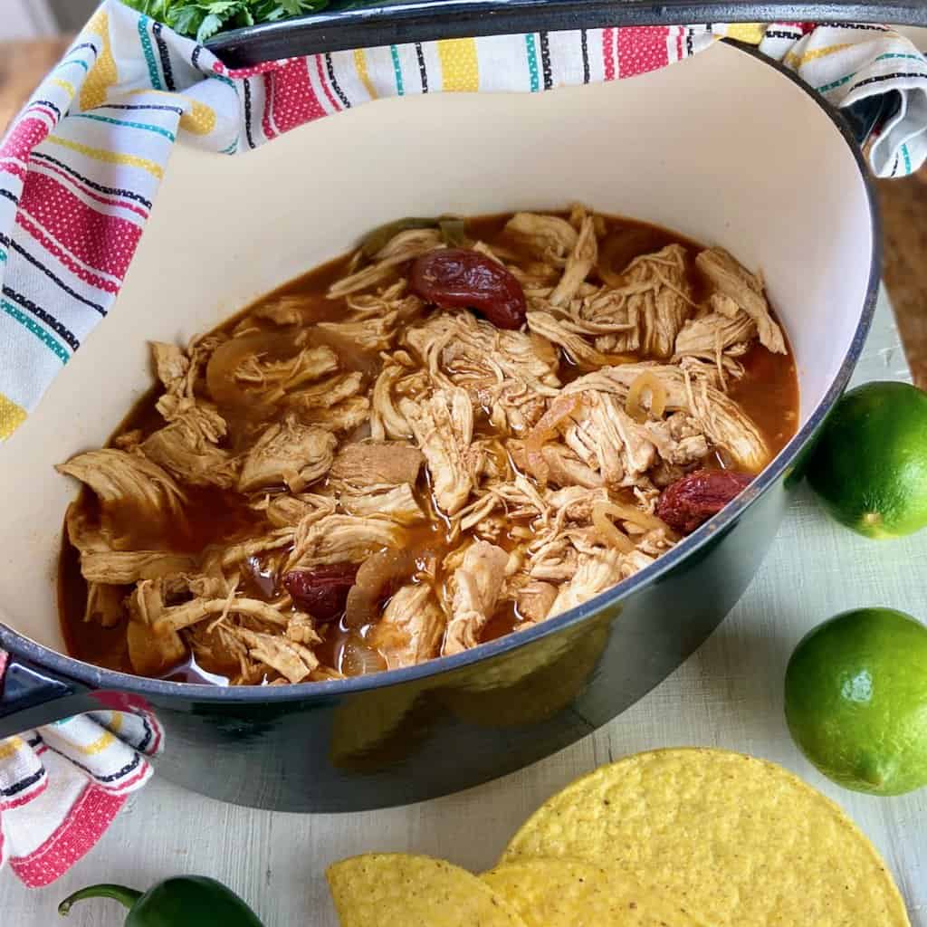 Dutch Oven Chicken Carnitas in black pot.