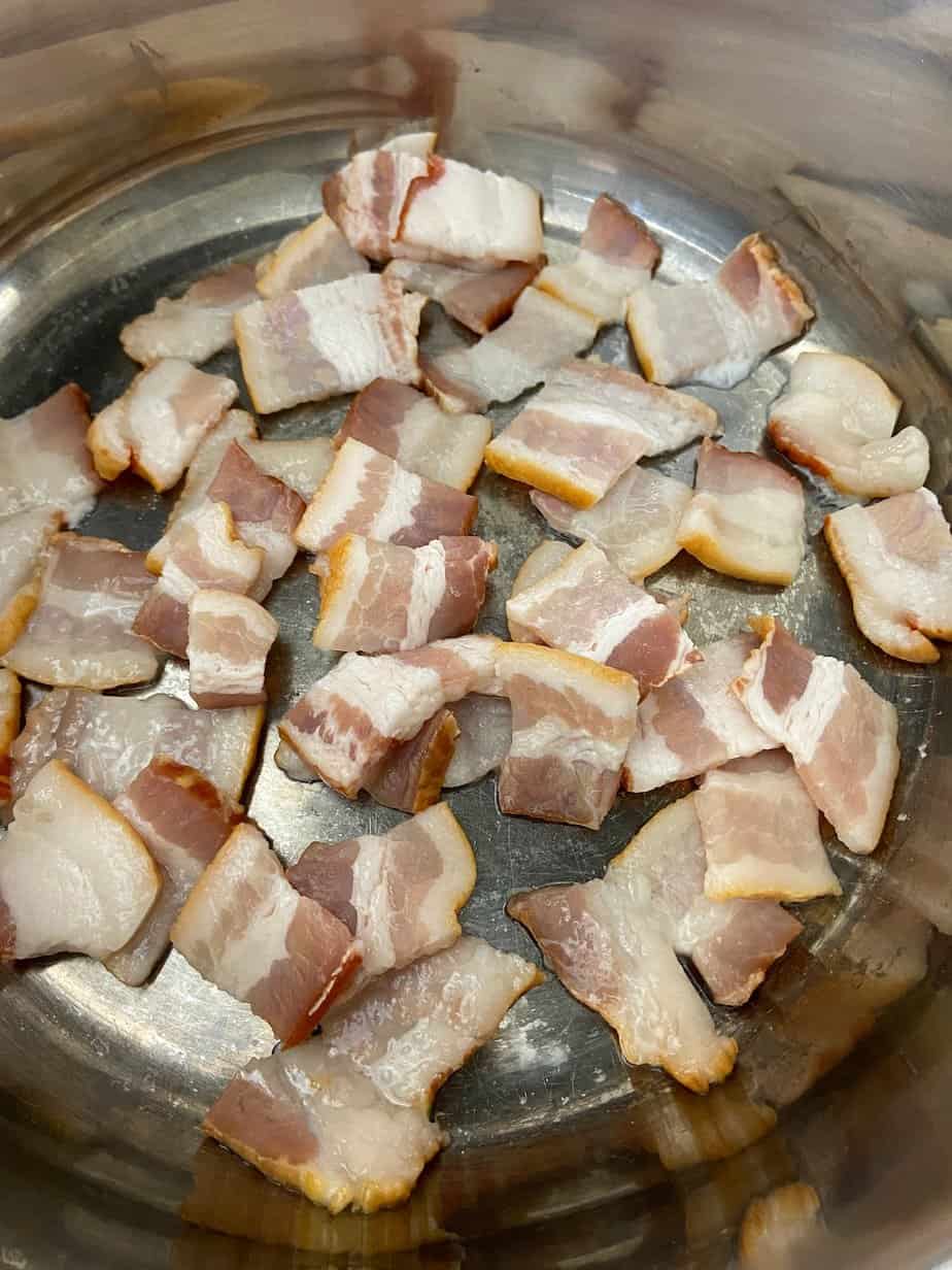 Cut bacon in frying pan.