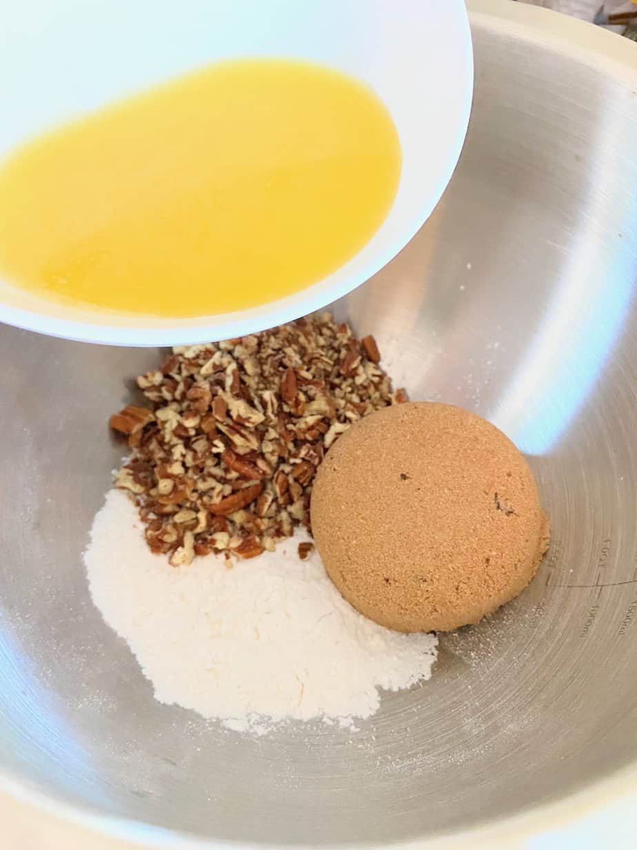 Chopped pecans, brown sugar, flour and melted butter in mixing bowl.