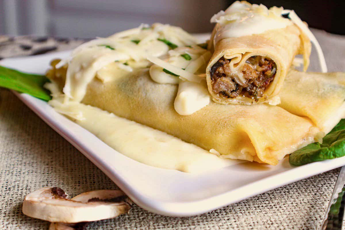 Crepe cut in half showing sausage filling.