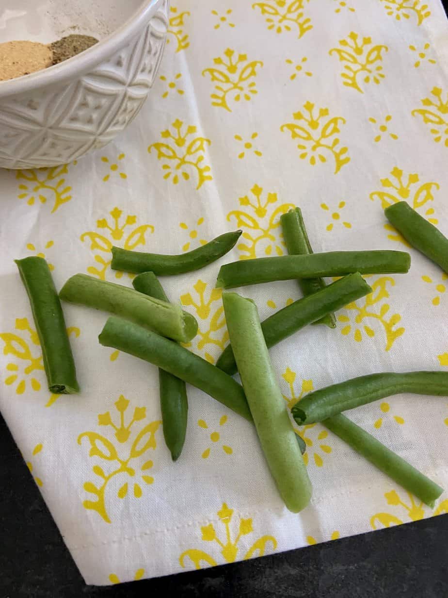 "Snapped" green beans on counter.