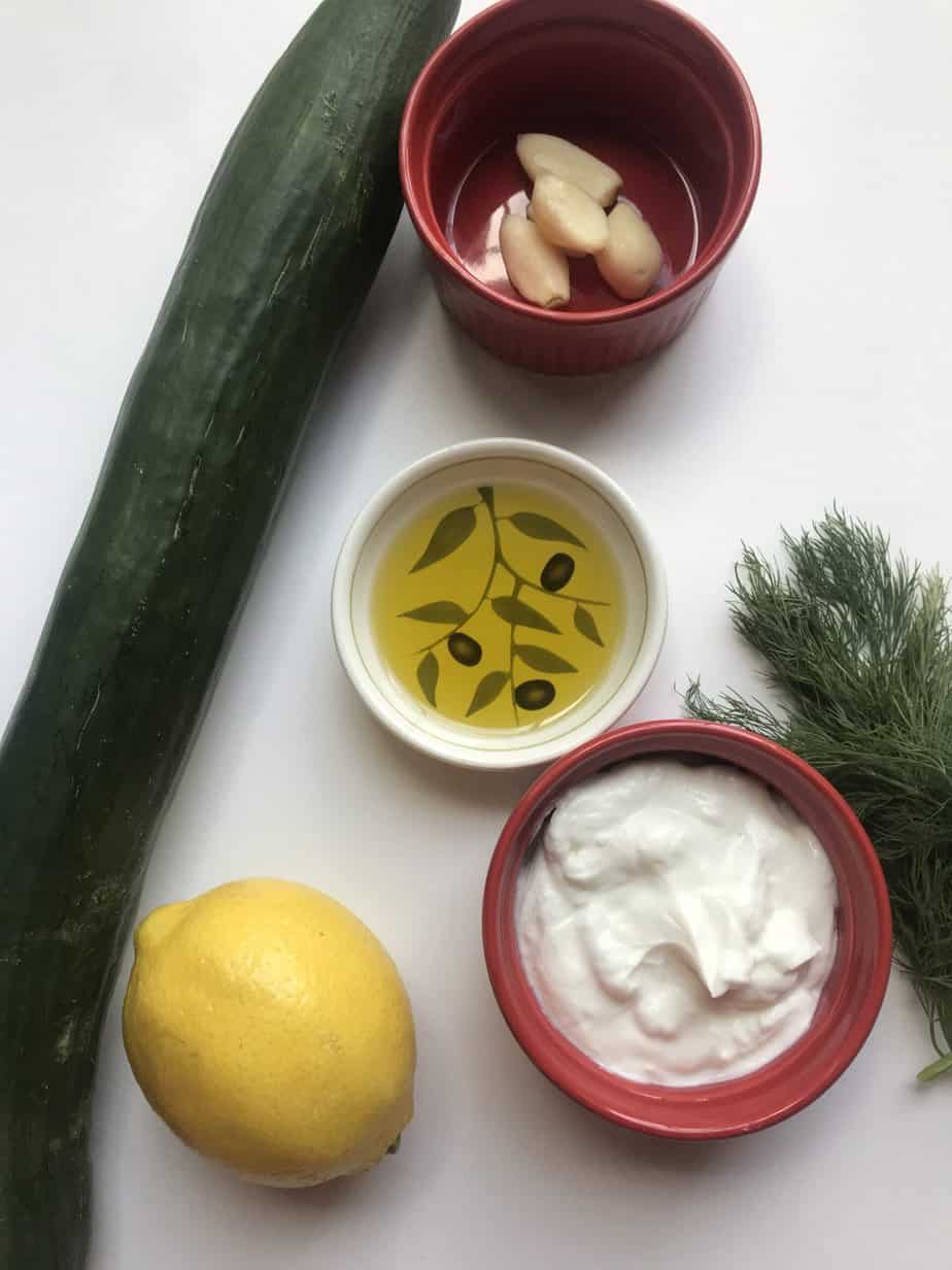 Ingredients for Tzatziki Greek Yogurt Dip on white counter.