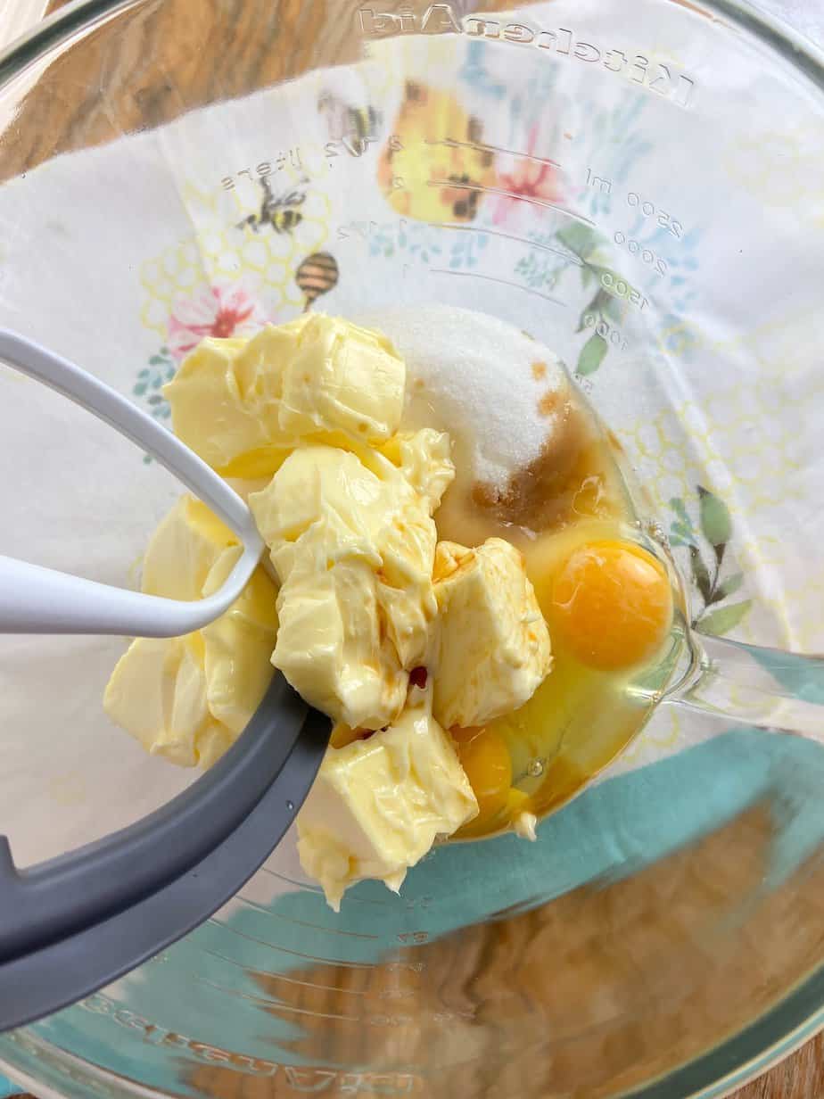 Butter, sugar, eggs and vanilla extract in mixing bowl.