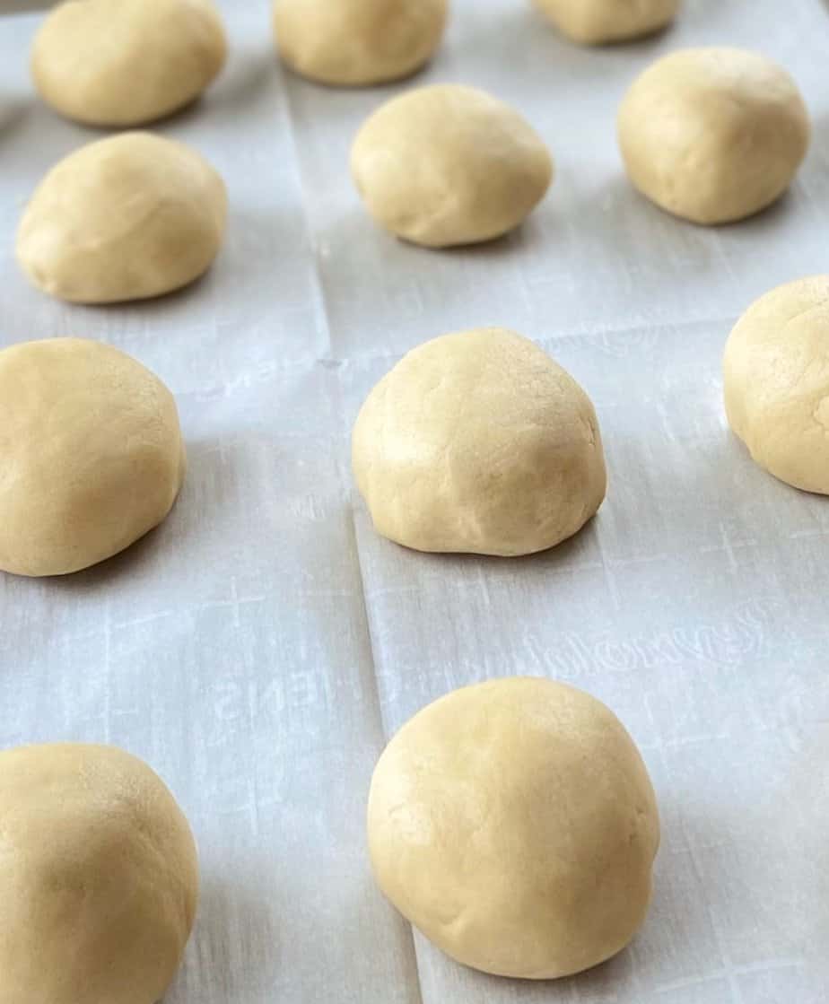 Cookie dough ball on baking sheet.