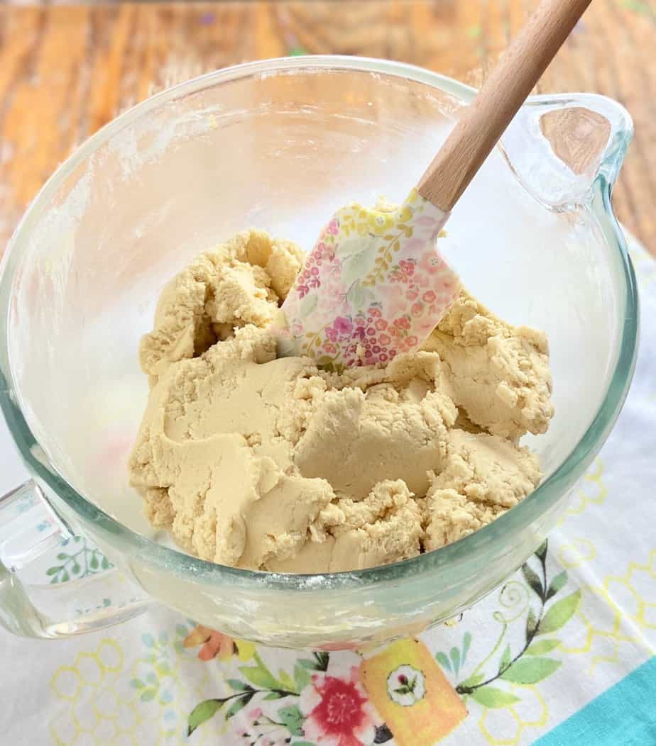 Cookie dough batter in clear mixing bowl.