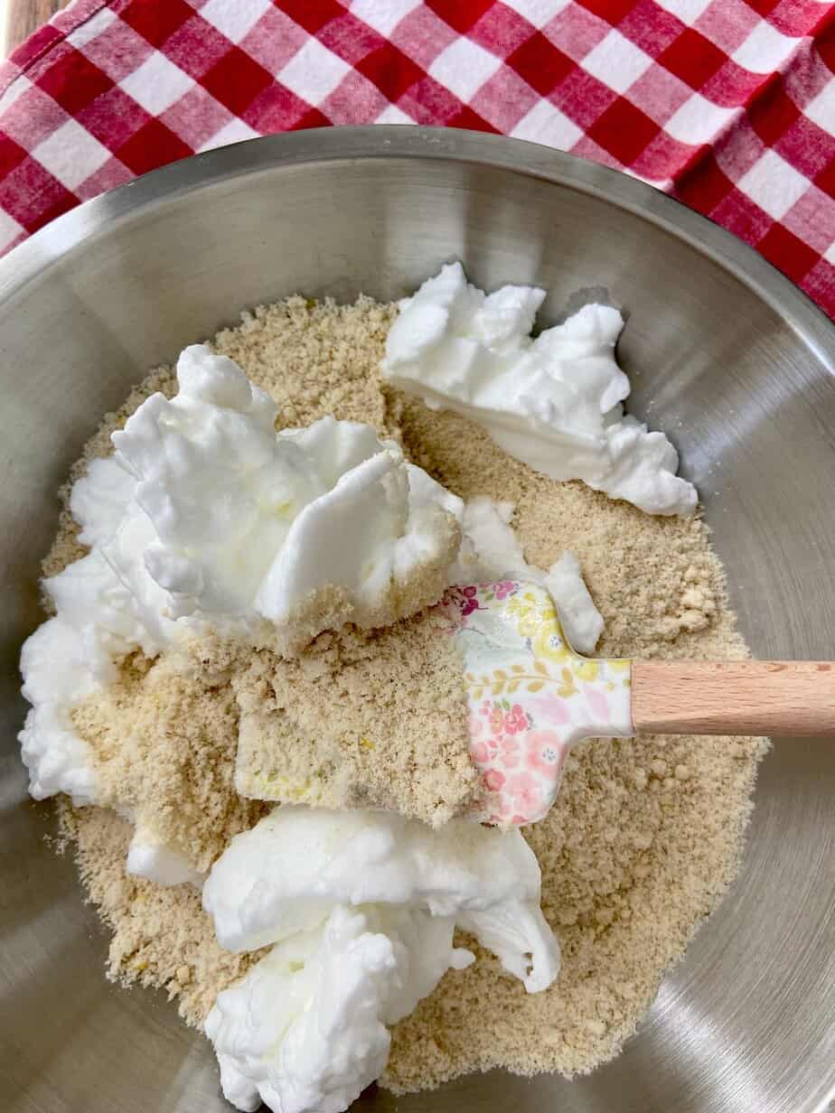 Egg whites being incorporated into almond mixture.