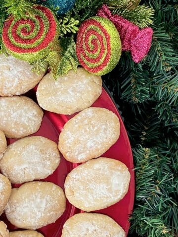 Italian almond cookies on red serving platter.