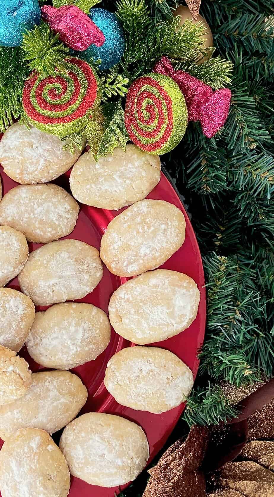 Italian almond cookies on red plate.