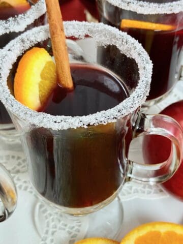 Close up image of mulled wine in glass mug.