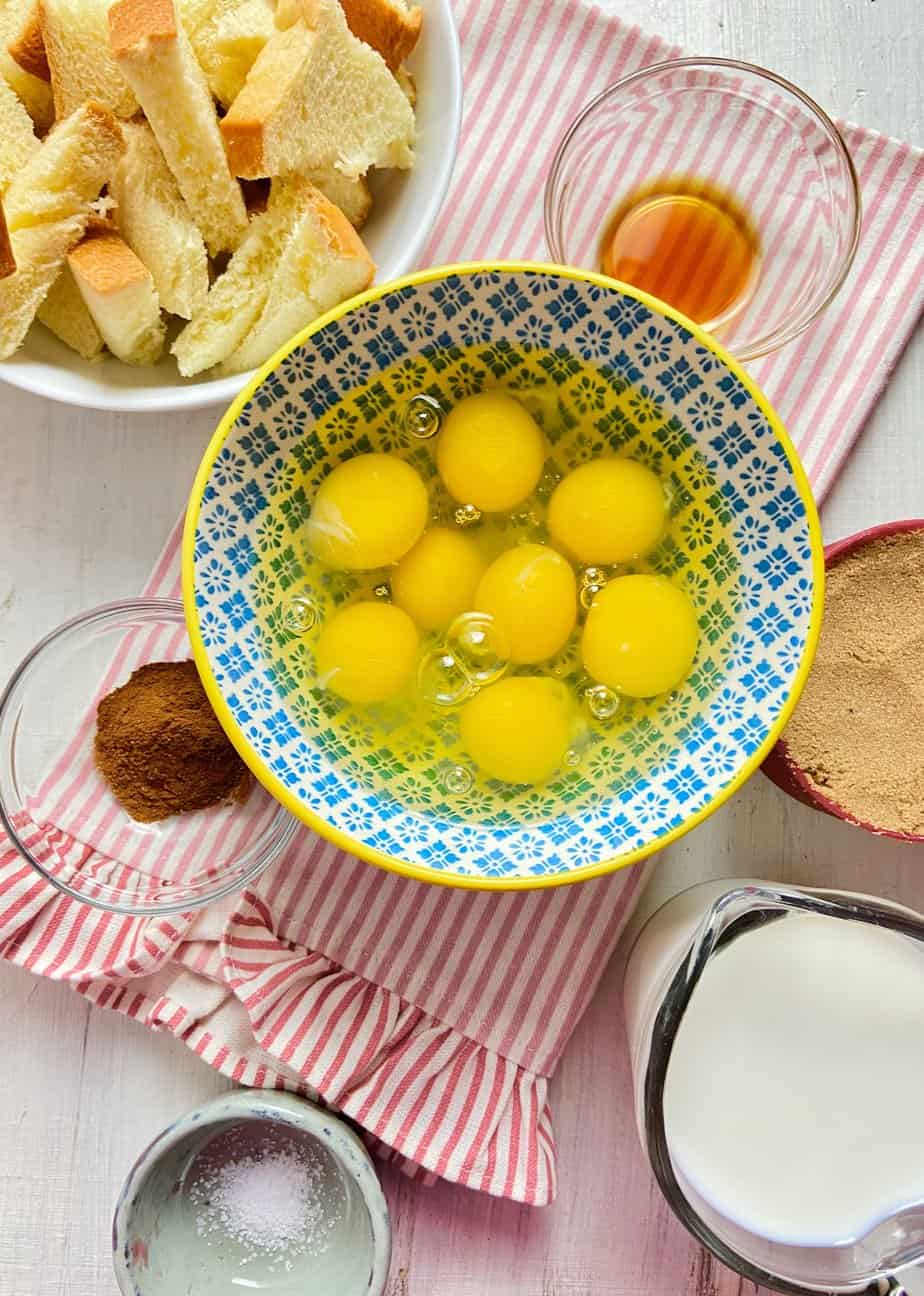 Ingredients for french toast on white wooden tabletop.