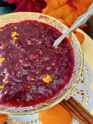 Cranberry sauce in crystal bowl with gold rim.