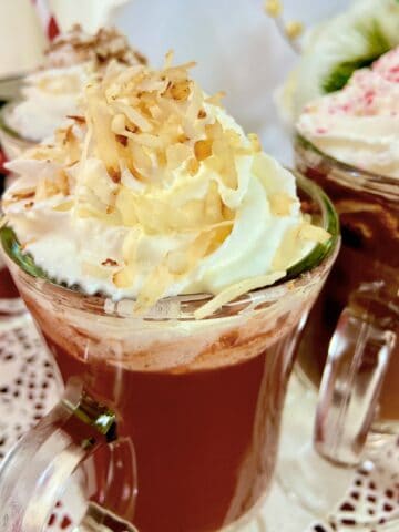 Hot chocolate with toasted coconut shavings on top of whipped cream