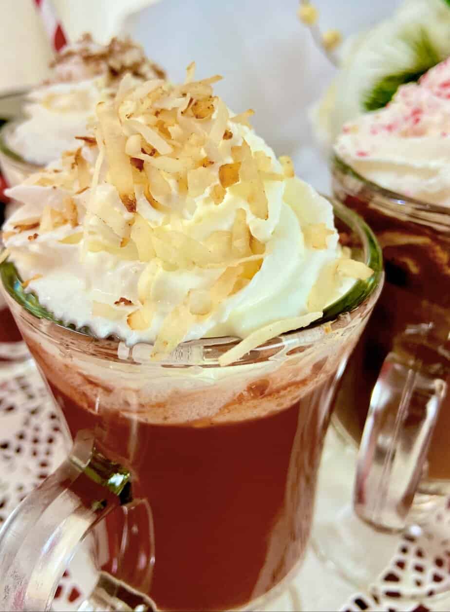 Hot chocolate with toasted coconut shavings on top of whipped cream