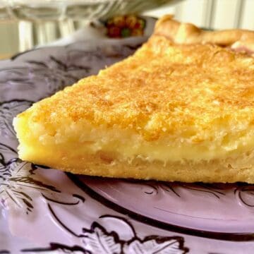 Closeup of slice of pie on purple plate.