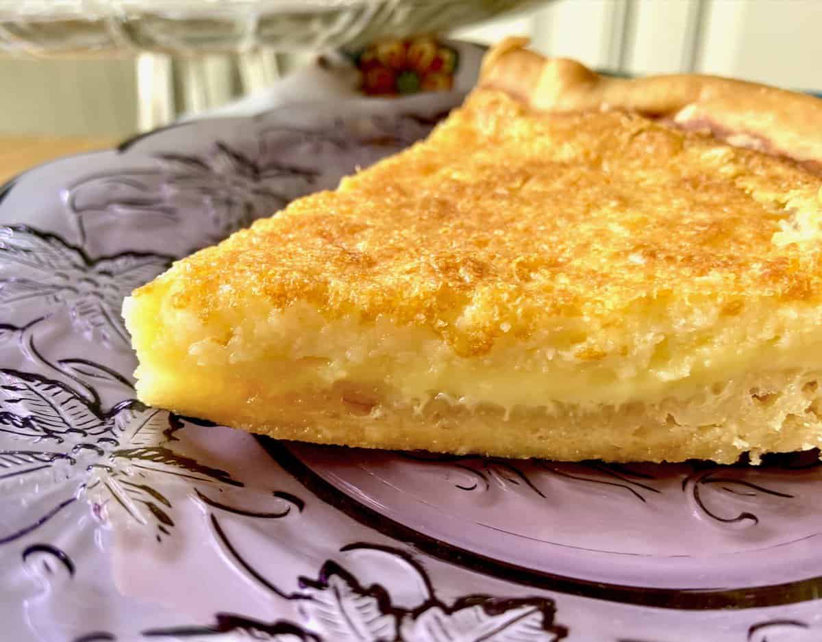 Closeup of slice of pie on purple plate.