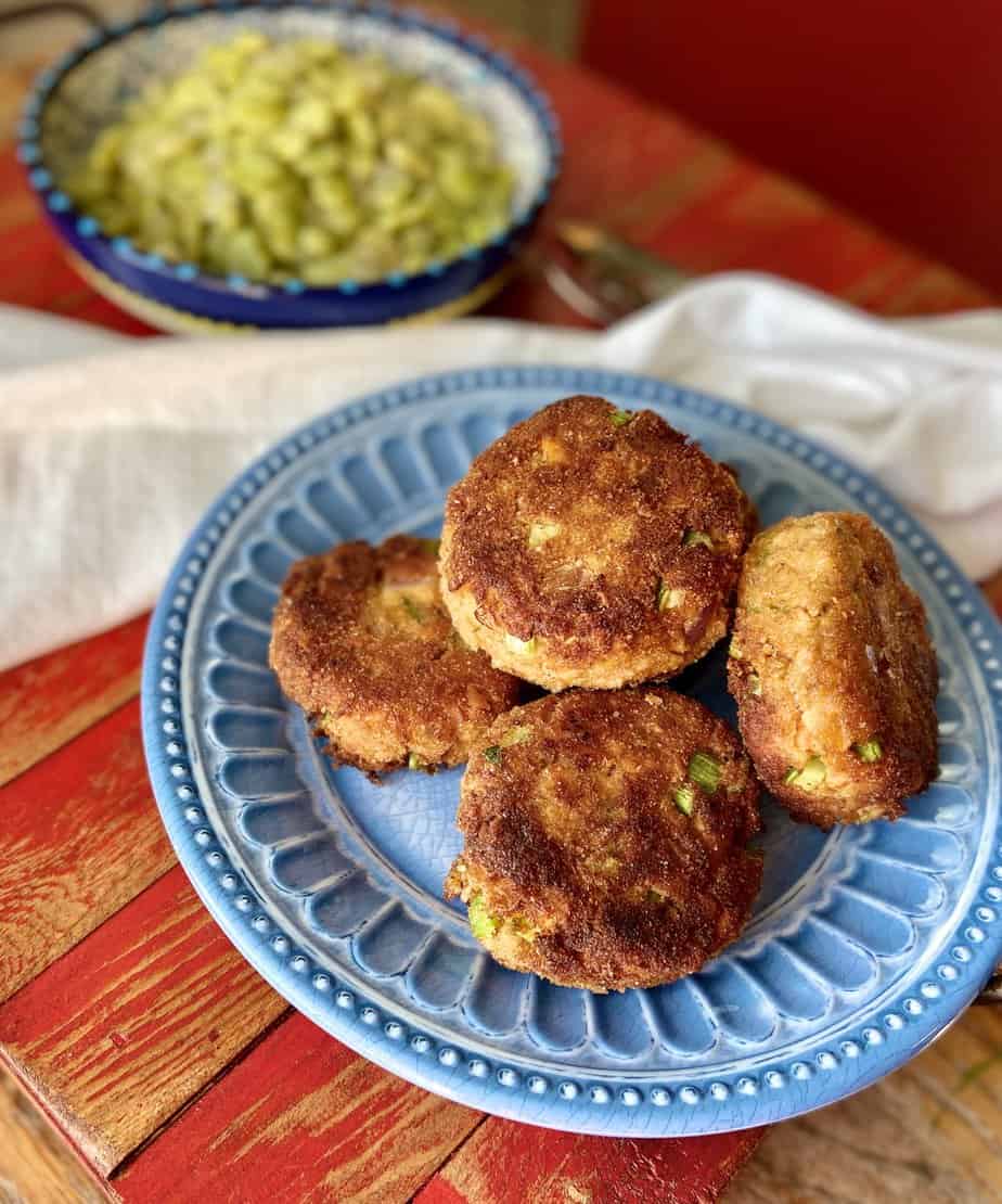 Salmon patties on blue plate.