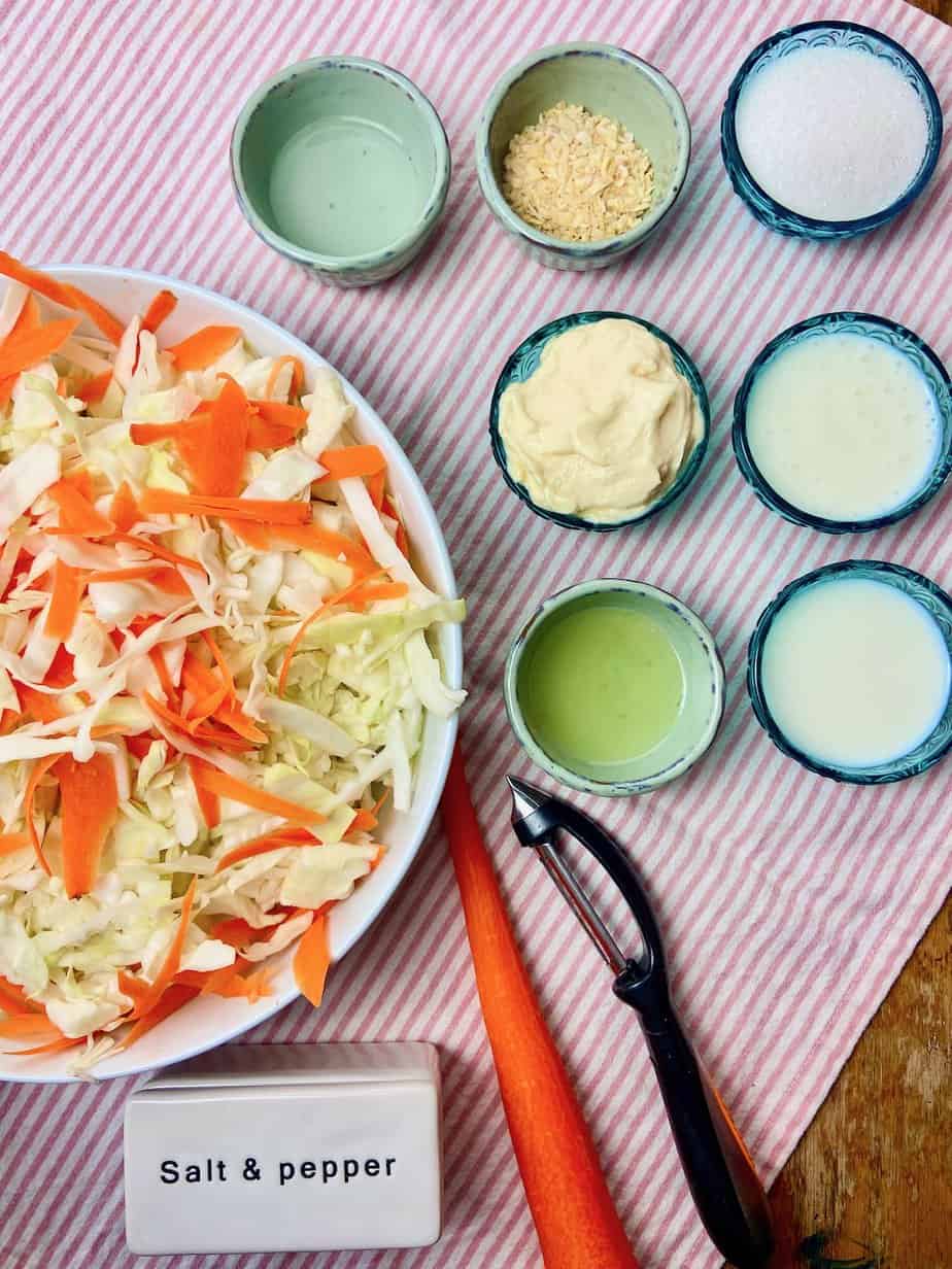 Coleslaw ingredients in small ramekins on tabletop.