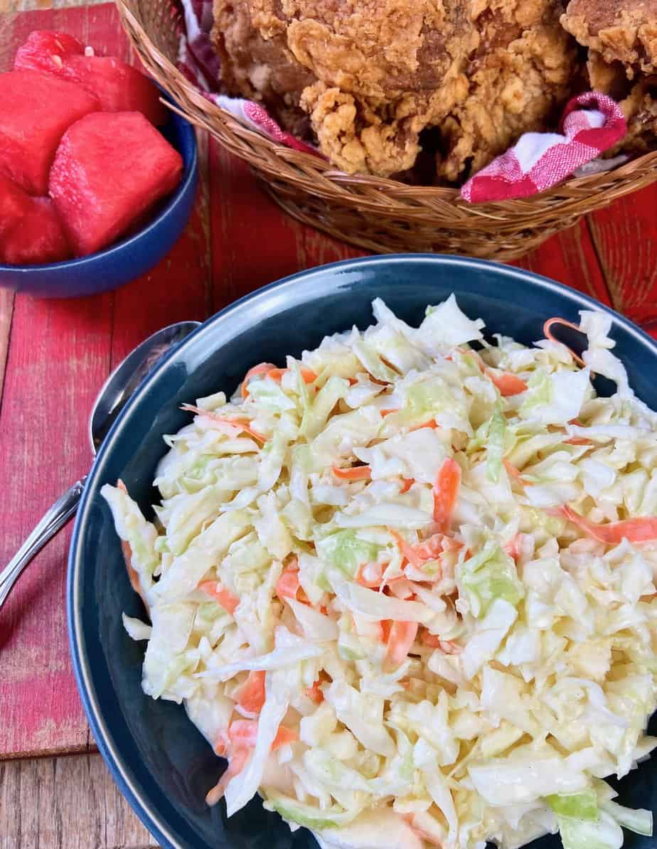 Creamy coleslaw in black bowl.