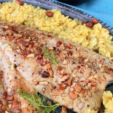 Pan fried trout with toasted smokehouse almonds on serving platter.