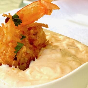 Coconut fried shrimp dipped in dipping sauce.