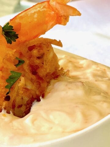 Coconut fried shrimp dipped in dipping sauce.